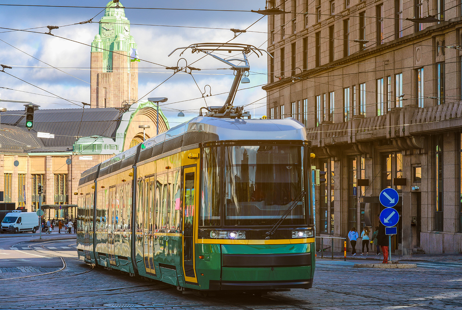 green tram transporting people in the central part of the Helsinki city, Finland